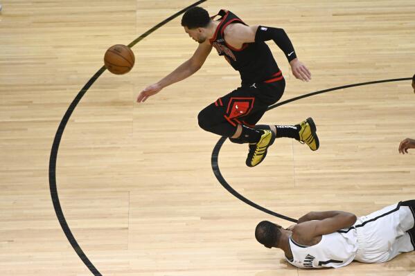 Chicago Bulls guard Zach LaVine, top, chases a ball that was tippled by Brooklyn Nets forward Kevin Durant (7) during the second half of an NBA basketball game Tuesday, May 11, 2021, in Chicago. (AP Photo/Matt Marton)