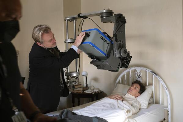 This image released by Universal Picture shows filmmaker Christopher Nolan working with an IMAX camera on the set with actor Cillian Murphy during the filming of 