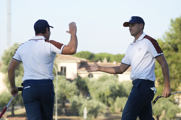 Europe's Ludvig Aberg, right, with playing partner Europe's Viktor Hovland celebrates on the 6th green after putting during his morning Foursomes match at the Ryder Cup golf tournament at the Marco Simone Golf Club in Guidonia Montecelio, Italy, Saturday, Sept. 30, 2023. (AP Photo/Gregorio Borgia )