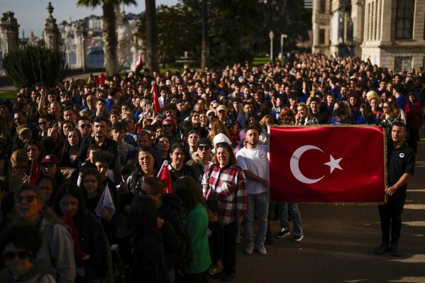 People arrive to pay tribute to Turkey's founding father Mustafa Kemal Ataturk during the 85th anniversary of his death at Dolmabahce palace in Istanbul, Turkey, Friday, Nov. 10, 2023. (AP Photo/Francisco Seco)