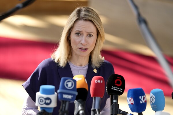 FILE - Estonia's Prime Minister Kaja Kallas speaks with the media as she arrives for an EU summit at the European Council building in Brussels, on June 30, 2023. The husband of Estonia’s government leader said Friday Aug. 25, 2023 he will sell stakes in a company with ties to Russia, a situation that has caused a crisis for Estonian Prime Minister Kaja Kallas, one of Europe’s most outspoken supporters of Ukraine. (AP Photo/Virginia Mayo, File)