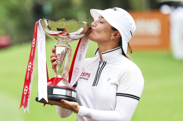 Hannah Green of Australia kisses he trophy after winning the HSBC Women's Wold Championship at the Sentosa Golf Clubin Singapore Sunday, March 3, 2024. (AP Photo/Danial Hakim)