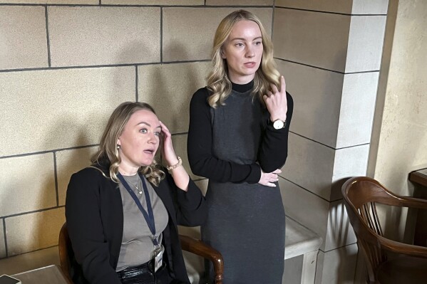 State Sen. Megan Hunt, right, looks on the floor of the Nebraska Legislature with her legislative aide, Hanna Murdoch, as lawmakers prepare for a veto override vote on her bill that would have allowed needle exchange programs in the state, Tuesday, March 12, 2024, in Lincoln, Neb. The bill failed to get the 30 votes in needed to override Gov. Jim Pillen's veto. (AP Photo/Margery Beck)
