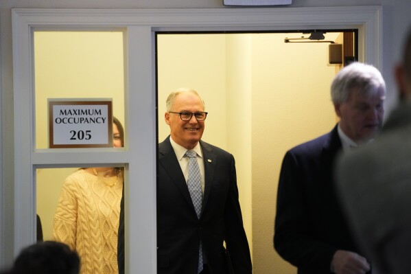 Washington Gov. Jay Inslee arrives during a legislative session preview in the Cherberg Building at the Capitol, Thursday, Jan. 4, 2024, in Olympia, Wash. (AP Photo/Lindsey Wasson)