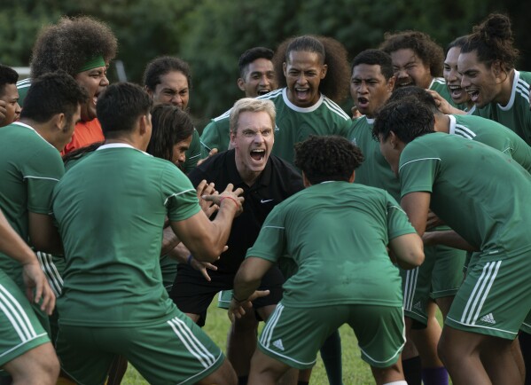 This image released by Searchlight Pictures shows Michael Fassbender, center, in a scene from "Next Goal Wins." (Hilary Bronwyn Gayle/Searchlight Pictures via AP)