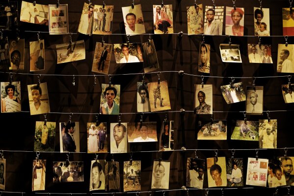 FILE - In this Friday, April 5, 2019 file photo, family photographs of some of those who died hang on display in an exhibition at the Kigali Genocide Memorial centre in the capital Kigali, Rwanda. Félicien Kabuga, a former radio station owner, appeared Wednesday in a United Nations courtroom to face charges that he armed and incited militias that took part in Rwanda's 1994 genocide. It was the first time Kabuga had appeared before the U.N.'s International Residual Mechanism for Criminal Tribunals since he was transferred to The Hague following his arrest outside Paris in May. (AP Photo/Ben Curtis, File)