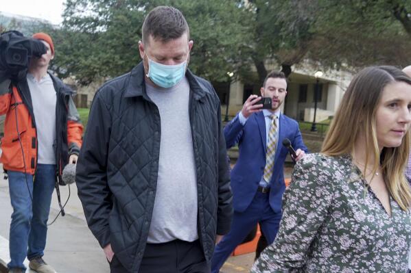 Texas men's basketball coach Chris Beard, second left, walks out of the Travis County Jail with his Defense Attorney Perry Q. Minton, right, in Austin, Texas, Monday, Dec. 12, 2022. Beard was arrested on a felony family violence charge. (Ricardo B. Brazziell//Austin American-Statesman via AP)