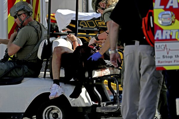 
              Medical personnel tend to a victim following a shooting at Marjory Stoneman Douglas High School in Parkland, Fla., on Wednesday, Feb. 14, 2018. (John McCall/South Florida Sun-Sentinel via AP)
            