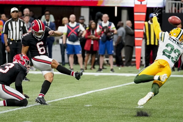 Atlanta Falcons place kicker Younghoe Koo, of South Korea, (6) kicks the game-winning field goal against Green Bay Packers cornerback Jaire Alexander (23) during the second half of an NFL football game, Sunday, Sept. 17, 2023, in Atlanta. The Atlanta Falcons won 25-24. (AP Photo/Brynn Anderson)