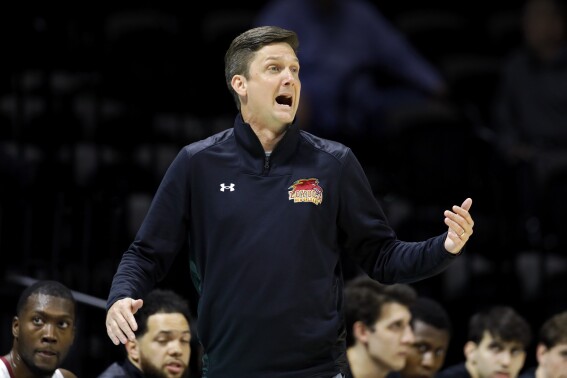 FIlE - Loyola-New Orleans coach Stacy Hollowell reacts during the first half of the team's NAIA men's championship college basketball game against Talladega on March 22, 2022, in Kansas City, Mo. The University of New Orleans has hired Hollowell as basketball coach. Two years ago, Hollowell coached Loyola to an NAIA championship. Following that season, he joined the staff of then-Mississippi coach Kermit Davis, but left Ole Miss in 2023 after Davis was fired. (AP Photo/Colin E. Braley, File)