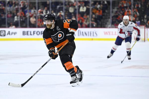 Philadelphia Flyers' Claude Giroux skates up ice with the puck during the second period of an NHL hockey game against the Washington Capitals, Saturday, Feb. 26, 2022, in Philadelphia. (AP Photo/Derik Hamilton)