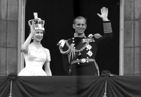 FILE - In this June 2, 1953 file photo, Britain's Queen Elizabeth II and her husband, the Duke of Edinburgh, wave from the balcony of Buckingham Palace, London, following the Queen's coronation at Westminster Abbey. Buckingham Palace says Prince Philip, husband of Queen Elizabeth II, has died aged 99. (AP Photo/Leslie Priest, File)