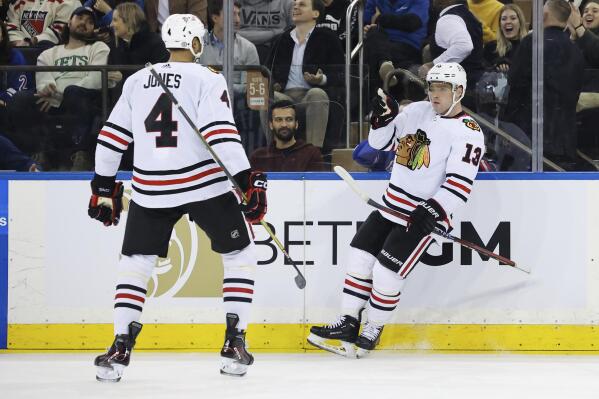 Chicago Blackhawks center Max Domi (13) celebrates with defenseman Seth Jones (4) after scoring a goal against the New York Rangers during the second period of an NHL hockey game, Saturday, Dec. 3, 2022, in New York. (AP Photo/Jessie Alcheh)