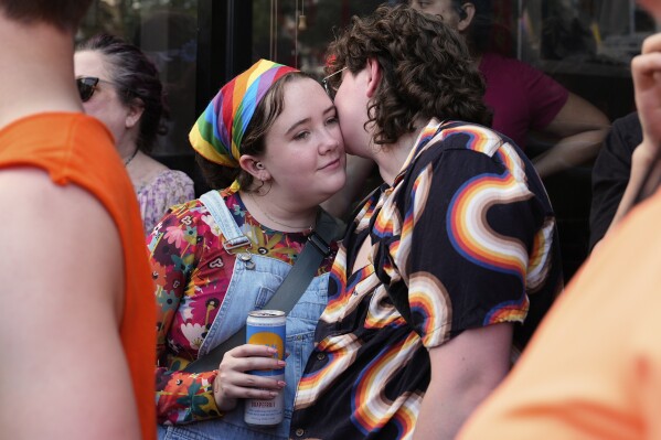People attend the World Pride parade, Saturday, June 7, 2025, in Washington. (AP Photo/Julia Demaree Nikhinson)