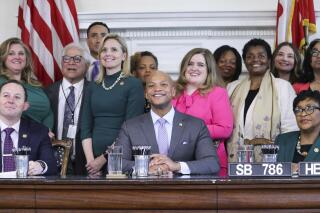 Maryland Gov. Wes Moore and state lawmakers pose for photos at a bill-signing ceremony on Wednesday, May 3, 2023, in Annapolis, Md., where Moore signed legislation to protect abortion rights in the state. (AP Photo/Brian Witte)