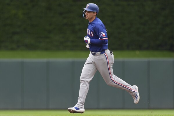 Texas Rangers' Corey Seager runs the bases after hitting a two-run home run during the third inning of a baseball game against the Minnesota Twins, Sunday, May 26, 2024, in Minneapolis. (AP Photo/Abbie Parr)