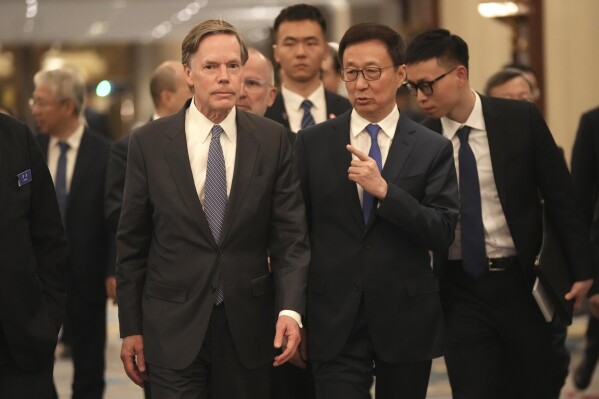 Chinese Vice President Han Zheng, center right, chats with with U.S. ambassador to China Nicholas Burns as they attend an Amcham event held in Beijing, China on Friday, March 1, 2024. Chinese Vice President Han Zheng pledged Friday to provide more opportunities for foreign companies in China as the government tries to restore confidence in the world’s second largest economy. (AP Photo/Tatan Syuflana)