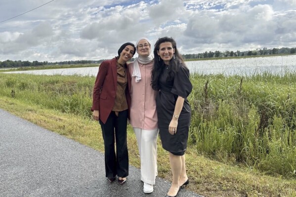 This photo provided by the Ozturk legal team shows Rumeysa Ozturk, center, with Nora Ahmed of ACLU Louisiana and Mahsa Khanbabai of Khanbabai Law on Friday, May 9, 2025, in Basile, La., shortly after her release from an immigration detention center. (Ozturk legal team via AP)