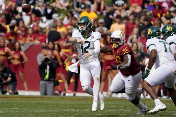 Baylor quarterback Blake Shapen (12) throws a pass ahead of Iowa State defensive lineman J.R. Singleton (56) during the second half of an NCAA college football game, Saturday, Sept. 24, 2022, in Ames, Iowa. Baylor won 31-24. (AP Photo/Charlie Neibergall)