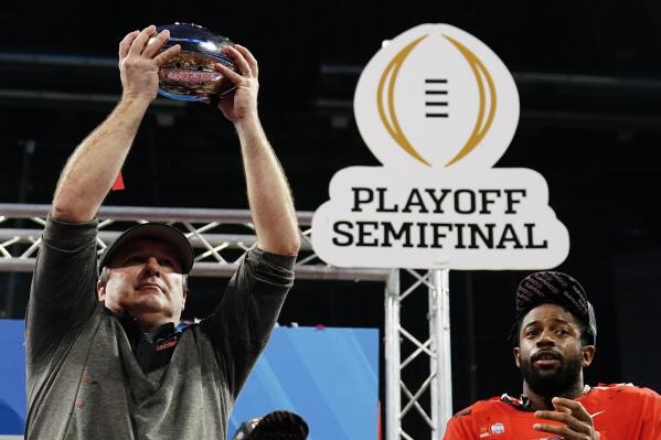 Georgia head coach Kirby Smart holds the The George P. Crumbley Trophy after the Peach Bowl NCAA college football semifinal playoff game between Georgia and Ohio State, Sunday, Jan. 1, 2023, in Atlanta. Georgia won 42-41. (AP Photo/Brynn Anderson)