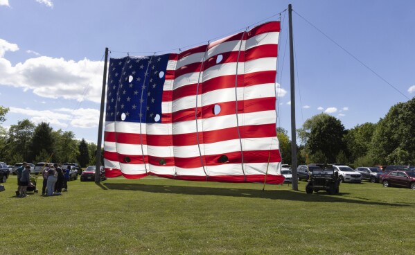 A giant flag is seen on display outside the National Flag Foundation in Waubeka, Wis., on June 9, 2024. Old Glory is venerated annually in Waubeka, the small town that lays claim to the first Flag Day. (AP Photo/Teresa Crawford)