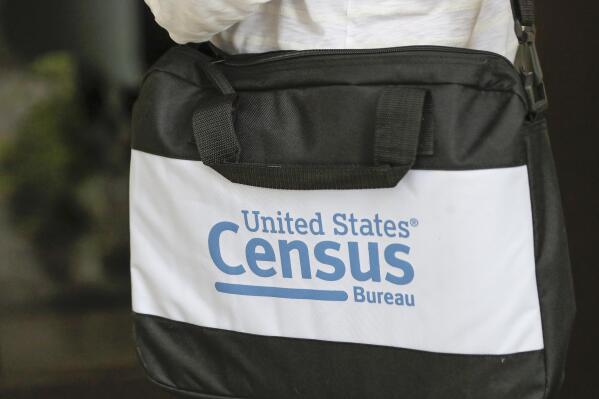FILE - A briefcase of a census taker is seen as she knocks on the door of a residence, Aug. 11, 2020, in Winter Park, Fla. A significant number of non-citizens appear to have been missed in the 2020 census, according to results from a U.S. Census Bureau simulation, during a head count of all U.S. residents in which the Trump administration tried but failed to prevent people in the country illegally from being tallied. (AP Photo/John Raoux, file)