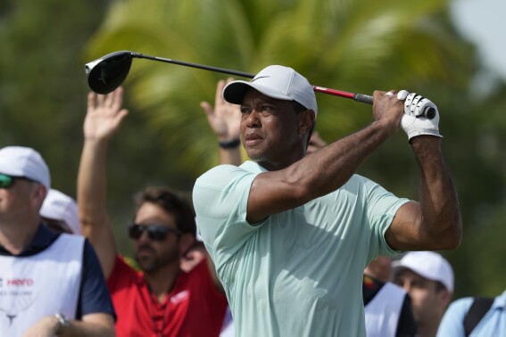 Tiger Woods watches his shot on the fourth tee during the third round of the Hero World Challenge PGA Tour at the Albany Golf Club, in New Providence, Bahamas, Saturday, Dec. 2, 2023. (AP Photo/Fernando Llano)