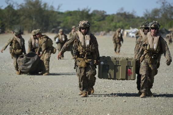 U.S. marines carry equipment at the Paredes Air Station at Pasuquin, Ilocos Norte province during a joint military exercise in northern Philippines on Monday, May 6, 2024. American and Filipino marines held annual combat-readiness exercises called Balikatan, Tagalog for shoulder-to-shoulder, in a show of allied military readiness in the Philippines' northernmost town facing southern Taiwan. (AP Photo/Aaron Favila)
