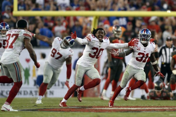 New York Giants players, including Antonio Hamilton (30), Sterling Shepard (87), Michael Thomas, and Dexter Lawrence (97) celebrate after the team defeated the Tampa Bay Buccaneers during an NFL football game Sunday, Sept. 22, 2019, in Tampa, Fla. (AP Photo/Jason Behnken)