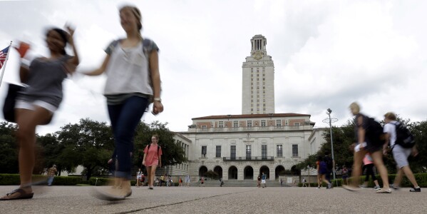 FILE - In this Sept. 27, 2012, file photo, students walk through the University of Texas at Austin campus near the school's iconic tower in Austin, Texas. A ban on diversity, equity and inclusion initiatives in higher education has led to more than 100 job cuts across university campuses in Texas, a hit echoed or anticipated in numerous other states where lawmakers are rolling out similar policies during an important election year. (AP Photo/Eric Gay, File)