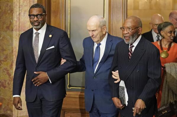 The Rev. Amos C. Brown, right, President Russell M. Nelson of The Church of Jesus Christ of Latter-day Saints, center, and Derrick Johnson, president and CEO of the NAACP, left, attend a news conference Monday, June 14, 2021, in Salt Lake City. Top leaders from the NAACP and The Church of Jesus Christ of Latter-day Saints announced $9.25 million in new educational and humanitarian projects as they seek to build on an alliance formed in 2018. (AP Photo/Rick Bowmer)