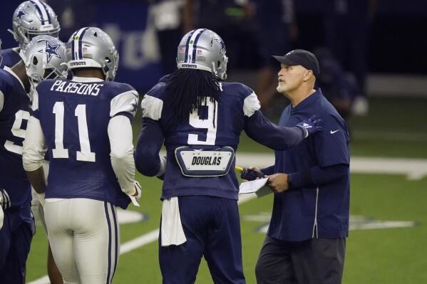 Dallas Cowboys defensive coordinator Dan Quinn, right, makes a point with linebackers Jaylon Smith (9), Micah Parsons and others during during NFL football practice in Frisco, Texas, Wednesday, Aug. 18, 2021. (AP Photo/LM Otero)