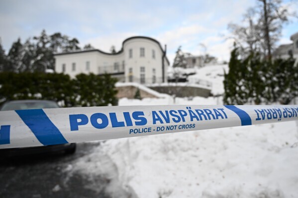 FILE - A police tape cordons off an area outside a house where Swedish Security Service allegedly arrested two people on suspicion of espionage in a predawn operation in Stockholm, Nov. 22, 2022. Sweden's prosecution authority on Wednesday appealed a ruling that acquitted a Russian-born Swedish businessman who had been accused of collecting information for Russia’s military intelligence service, the GRU, for almost a decade. (Fredrik Sandberg/TT News Agency via AP, File)