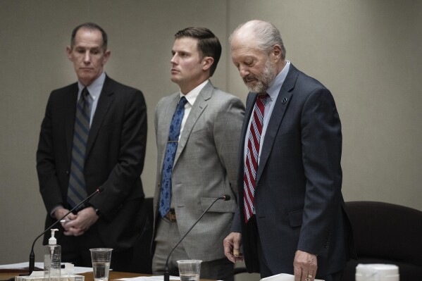 Attorneys Chris Madel, left, and Fred Bruno, right, stand by the side of former Minneapolis police Officer Justin Stetson, who was sentenced for beating Jaleel Stallings amid the civil unrest after George Floyd's murder, at the Hennepin County Government Center in Minneapolis, Monday, Oct. 23, 2023. (Richard Tsong-Taatarii/Star Tribune via AP, Pool)