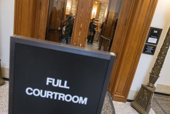 Minnesota DFL House Leader Rep. Melissa Hortman, back left, stands in a courtroom after oral arguments were presented to the Minnesota Supreme Court at the Minnesota Judicial Center in St. Paul, Minn., Thursday, Jan. 23, 2025. (Ben Hovland/Minnesota Public Radio via AP, Pool)