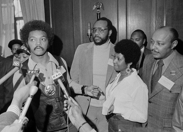 
              This March 26, 1972 file photo shows the Rev. Jesse Jackson speaking to reporters at the Operation PUSH Soul Picnic in New York as Tom Todd, vice president of PUSH, from second left, Aretha Franklin and Louis Stokes. Franklin died Thursday, Aug. 16, 2018 at her home in Detroit.  She was 76. (AP Photo/Jim Wells, File)
            