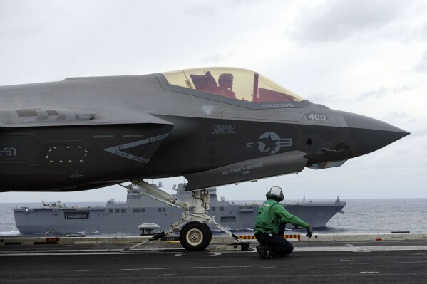 US Navy’s F-35C stealth fighter jet and crew prepare ready for a takeoff for a flight demonstration during the Annualex 23 joint naval exercise, from aircraft carrier USS Carl Vinson off the Japanese coast, Saturday, Nov. 11, 2023, involving about 30 vessels and 40 warplanes from the United States and its allies Japan, Australia and Canada and the Philippines participate amid China’s growing assertiveness in the regional seas. (AP Photo/Mari Yamaguchi).