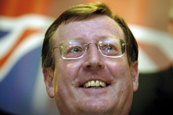 FILE - A delighted Ulster Unionist Party leader David Trimble speaks to the media at a hotel in Belfast, Northern Ireland, June 16, 2003, after winning a crucial vote with his party on its continued support for the Irish peace process. David Trimble, a former Northern Ireland first minister who won the Nobel Peace Prize for being a key architect of the Good Friday Agreement that ended decades of conflict, has died, the Ulster Unionist Party said Monday July 25, 2022. He was 77. (AP Photo/Peter Morrison, File)