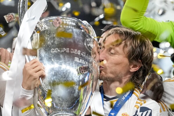 FILE - Real Madrid's Luka Modric kisses the trophy after winning the Champions League final soccer match between Borussia Dortmund and Real Madrid at Wembley stadium in London, Saturday, June 1, 2024. Spain eyes record, Italy seeks redemption. Both in Group B at Euro 2024 with Croatia and Albania. (AP Photo/Kirsty Wigglesworth, File)