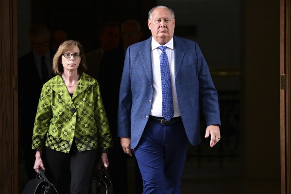 Former FirstEnergy CEO Charles Jones, right, walks with his lawyer Carole Rendon toward the courtroom at the Summit County courthouse in Akron, Ohio, on Tuesday, Feb. 13, 2024. Two fired top executives of FirstEnergy Corp. and Ohio’s former top utility regulator have pleaded not guilty in connection with a $60 million bribery scheme. (AP Photo/David Dermer)