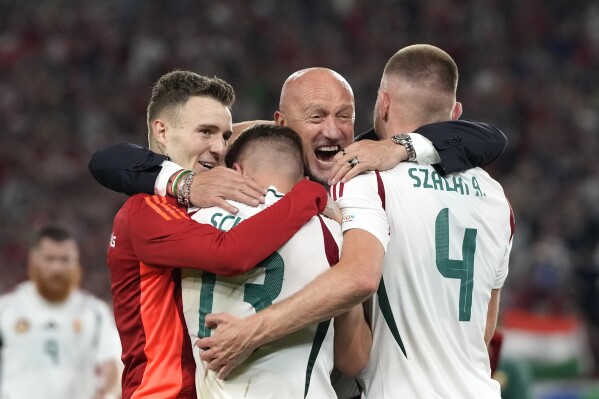 Hungary's coach Marco Rossi celebrates with players at the end of a Group A match between Scotland and Hungary at the Euro 2024 soccer tournament in Stuttgart, Germany, Sunday, June 23, 2024. (AP Photo/Antonio Calanni)
