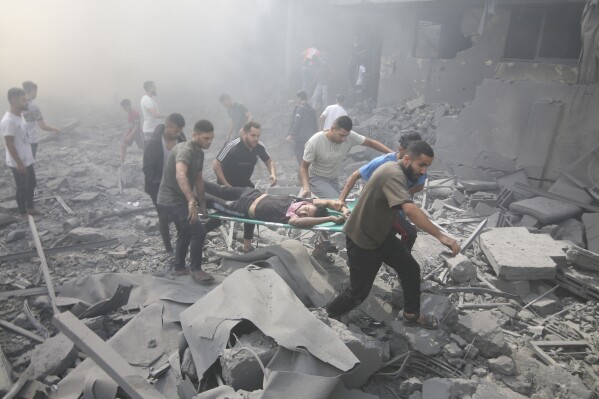 Palestinians evacuate wounded people after an Israeli airstrike in Rafah refugee camp, southern Gaza Strip, Thursday, Oct. 12, 2023. As Israel escalates its war on Hamas, it will confront many of the same dilemmas it has grappled with over decades of conflict with the Palestinians. It will want to punish Hamas like never before, but without killing so many Palestinian civilians that it loses international support. (AP Photo/Hatem Ali)
