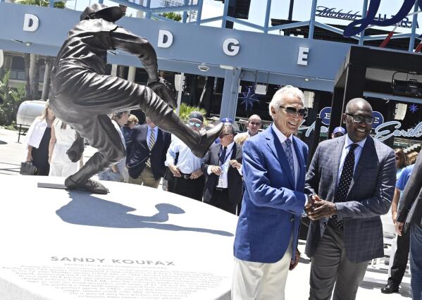 Sandy Koufax, left, with Clayton Kershaw poses next to his statue