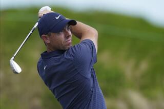 FILE - Rory McIlroy, of Northern Ireland, watches his shot on the second tee on day three of the Hero World Challenge PGA Tour at the Albany Golf Club, in New Providence, Bahamas, Saturday, Dec. 4, 2021. Rory McIlroy made it something of a ritual to write his goals for the season on the back of his boarding pass on the flight to the Middle East for his first tournament of the year, his opening event of 2022 at the Abu Dhabi Championship starting Thursday, Jan. 20, 2022. (AP Photo/Fernando Llano, File)