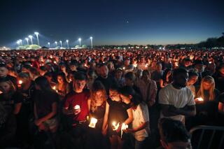 FILE - People attend a candlelight vigil for the victims of the shooting at Marjory Stoneman Douglas High School in Parkland, Fla., Thursday, Feb. 15, 2018. Nikolas Cruz has pleaded guilty, Wednesday, Oct. 20, 2021 to the 2018 shooting massacre that left 17 people dead at the school. Among his victims were caring staff members and gifted and outgoing students who had dreamed of dancing, medical, sports and military careers. Several died trying to save their classmates and students. Many of the survivors and victims' relatives have gone on to champion gun control and better security in schools or serve on the county school board. (AP Photo/Gerald Herbert)