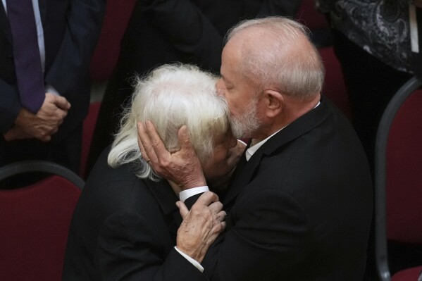 Brazil's President Luiz Inacio Lula Da Silva kisses Lucia Topolansky, widow of former Uruguayan President Jose Mujica, during funeral ceremonies for the late leader at the Legislative Palace in Montevideo, Uruguay, Thursday, May 15, 2025. (AP Photo/Matilde Campodonico)