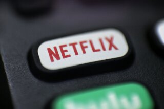 FILE - This Aug. 13, 2020, file photo shows a logo for Netflix on a remote control in Portland, Ore. Netflix’s video streaming service has surpassed 200 million subscribers for the first time as its expanding line-up of TV series and movies continues to captivate people stuck at home during the ongoing battle against the pandemic. The subscriber milestone highlighted Netflix’s fourth-quarter results released Tuesday, Jan. 19, 2021. (AP Photo/Jenny Kane, File)