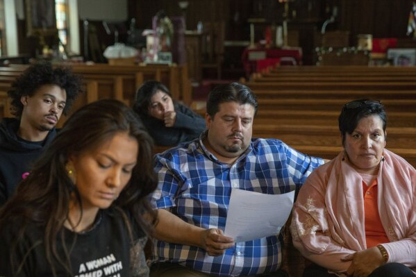 In this Wednesday, June 19, 2019 photo, attorney Roberto Lopez, center, of the Law Office of Schiller Pryer and pastor Jacobita Cortes from Adalberto Methodist Church participate in an emergency meeting plan of action on how to defend and protect undocumented communities of deportation at Lincoln Methodist Church in Chicago's Pilsen neighborhood.  With renewed pledges on mass deportations, immigrant rights activists have fine-tuned and ramped up one of their most basic organizing tools: The know-your-rights training. (AP Photo/Amr Alfiky)