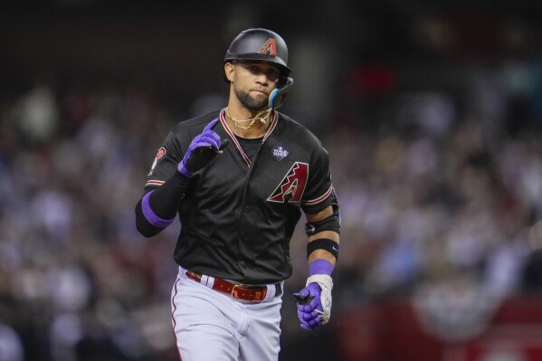 FILE - Arizona Diamondbacks' Lourdes Gurriel Jr. celebrates after a three-run home run against the Texas Rangers during the eighth inning in Game 4 of the baseball World Series, Oct. 31, 2023, in Phoenix. The Arizona Diamondbacks are keeping outfielder Gurriel Jr. on a $42 million, three-year contract that includes a club option for 2027, according to a person familiar with the deal. The person spoke to The Associated Press on condition of anonymity because the deal hasn't been officially announced. (AP Photo/Godofredo A. Vásquez, File)