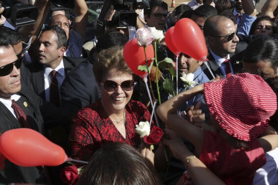 FILE - In this Sept. 6, 2016 file photo, Brazil's impeached President Dilma Rousseff receives flowers and gifts from supporters as she leaves the presidential residence, Alvorada Palace, in Brasilia, Brazil. The Academy Award nomination for a Brazilian documentary about the impeachment of then-President Dilma Rousseff has once again laid bare the polarization of Latin America's largest democracy. (AP Photo/Eraldo Peres, File)